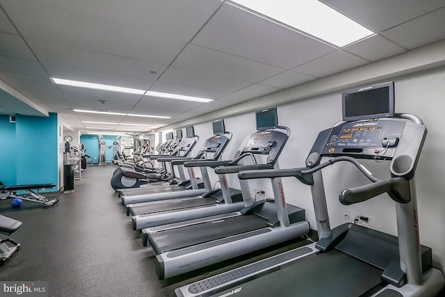 gym with a paneled ceiling