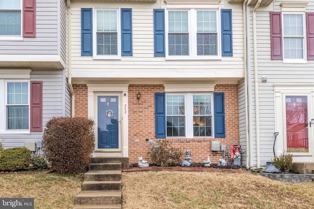 property entrance featuring brick siding