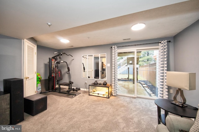 workout room featuring carpet and baseboards