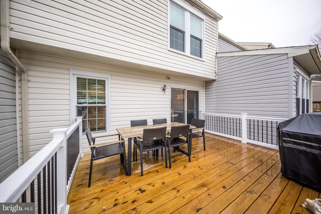 wooden terrace featuring outdoor dining area and area for grilling