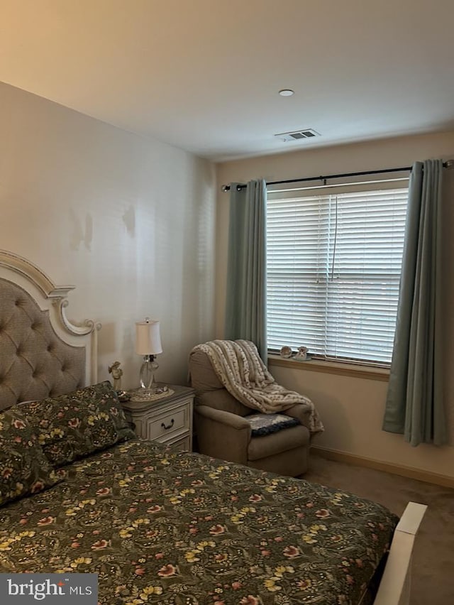 bedroom featuring visible vents and baseboards