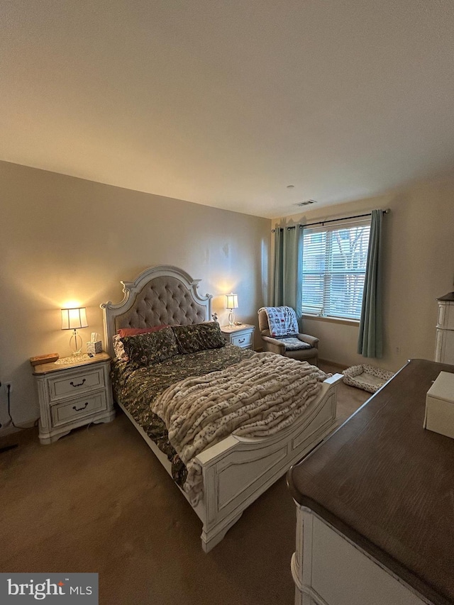 carpeted bedroom featuring visible vents