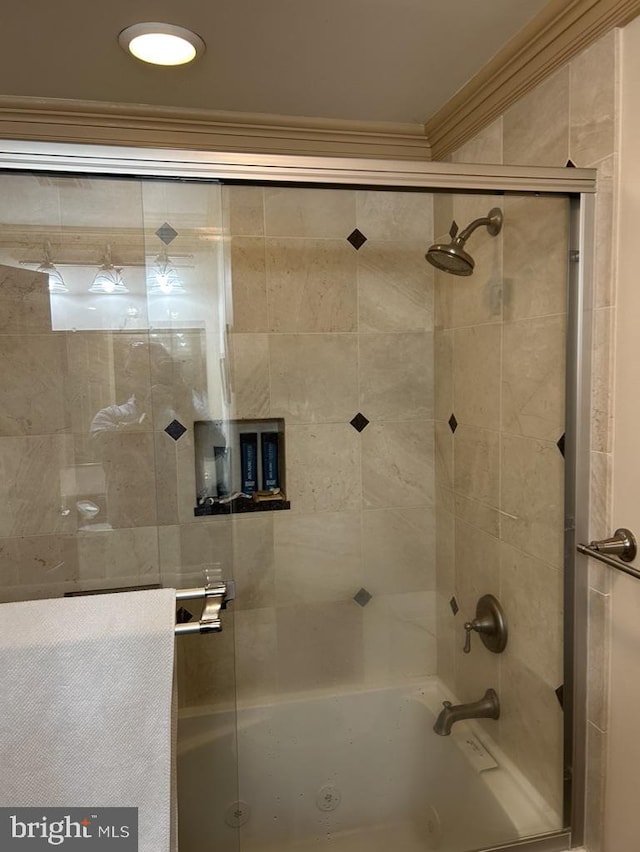 full bath featuring crown molding and bath / shower combo with glass door