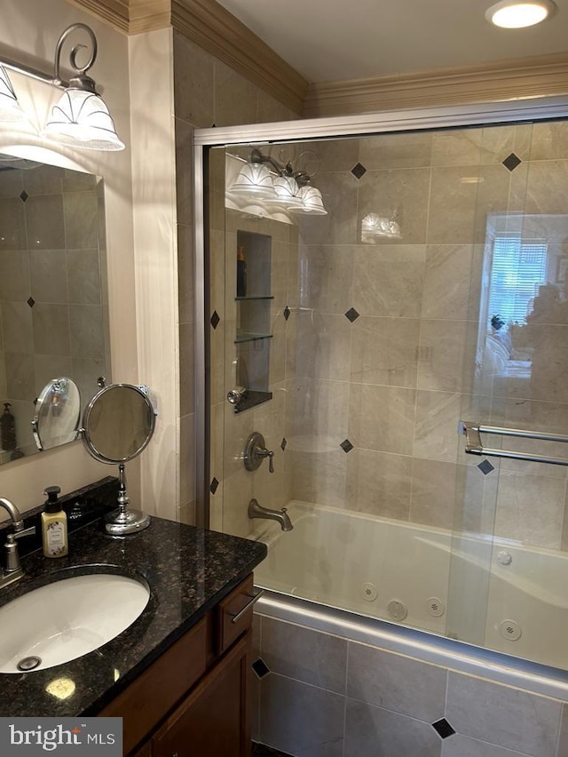 full bathroom with a combined bath / shower with jetted tub, ornamental molding, and vanity