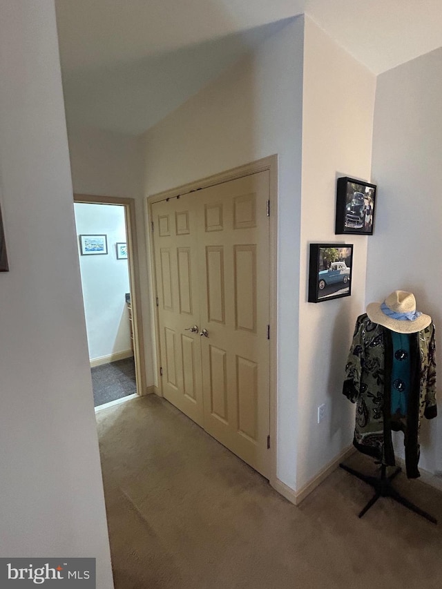 corridor with carpet floors and baseboards