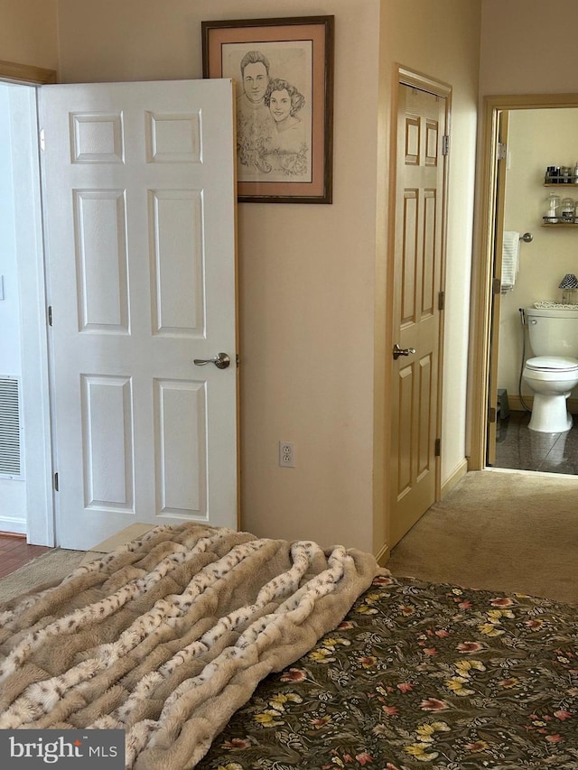 unfurnished bedroom featuring carpet floors and connected bathroom