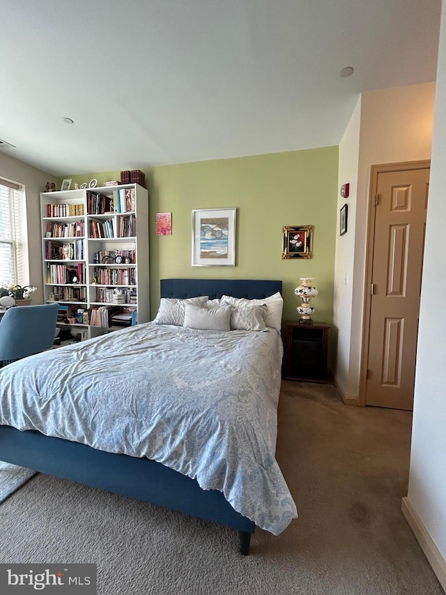 carpeted bedroom with baseboards