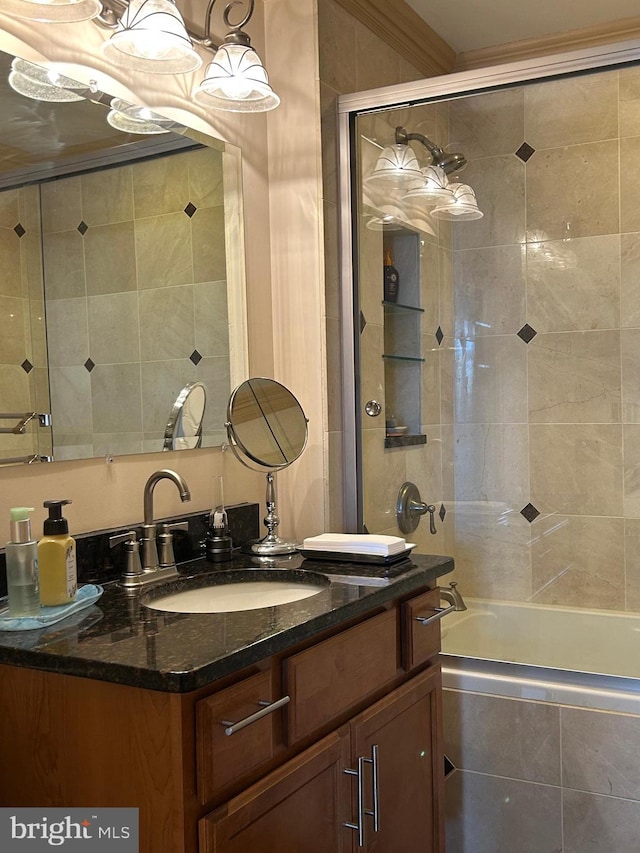 bathroom featuring ornamental molding, tiled shower / bath combo, and vanity