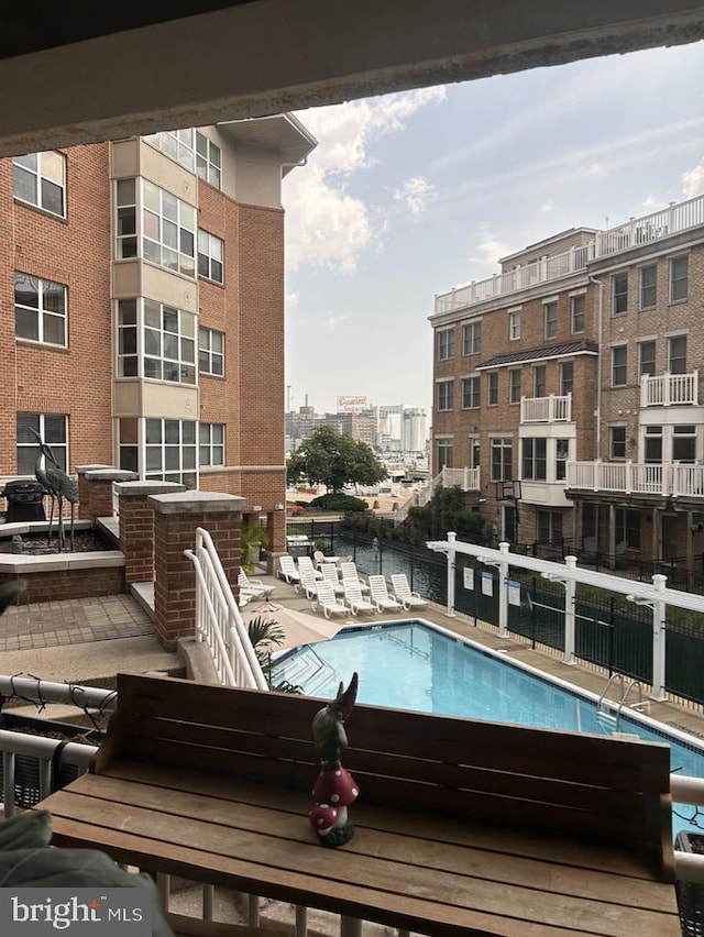 pool with a view of city and fence