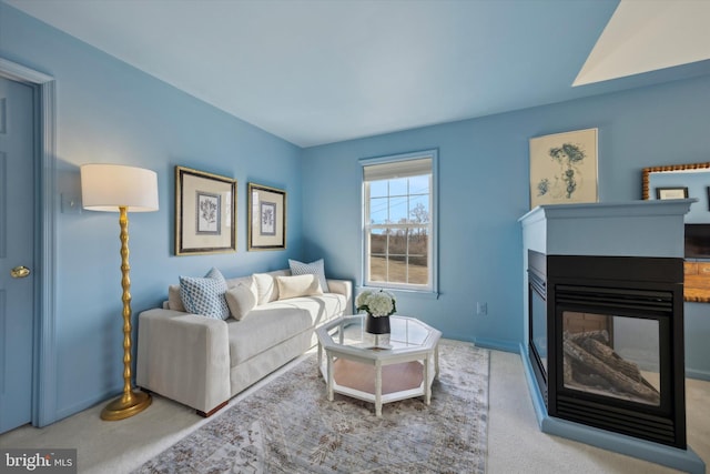 living room with carpet flooring and a multi sided fireplace