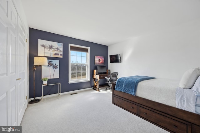 carpeted bedroom with visible vents and baseboards