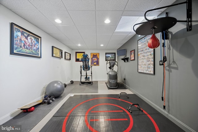 workout area with baseboards, a drop ceiling, and recessed lighting