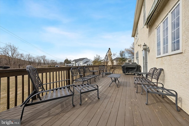 wooden deck featuring a grill