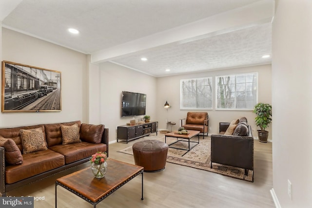 living room with recessed lighting, baseboards, and wood finished floors