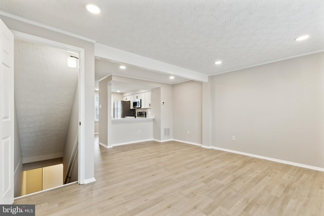 unfurnished living room featuring recessed lighting, visible vents, a textured ceiling, and light wood-style flooring