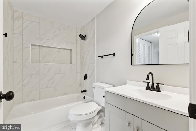 bathroom featuring marble finish floor, toilet, vanity, and bathtub / shower combination