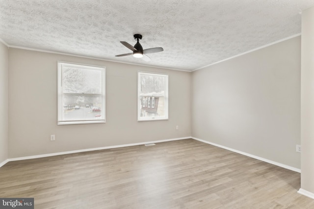 unfurnished room with ornamental molding, a textured ceiling, a ceiling fan, and wood finished floors