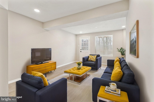 living room featuring recessed lighting, baseboards, and wood finished floors