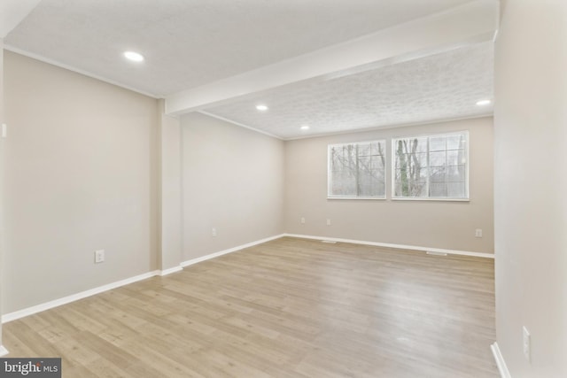 empty room featuring recessed lighting, light wood-style floors, and baseboards