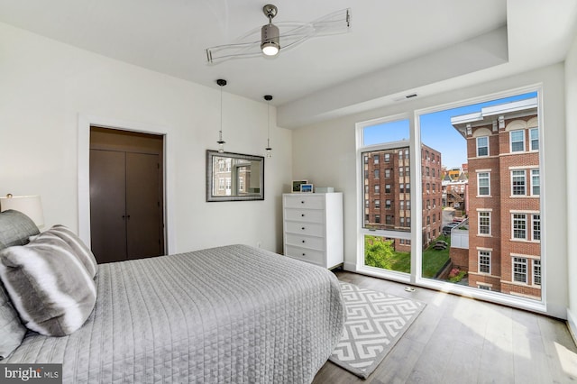 bedroom featuring visible vents, ceiling fan, and wood finished floors