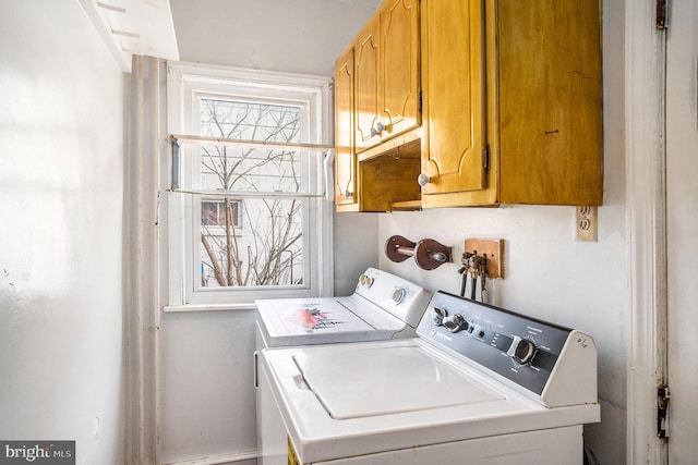 washroom with washer and dryer and cabinet space