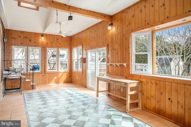 sunroom / solarium featuring lofted ceiling with beams and ceiling fan