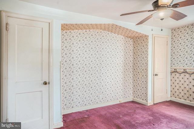 unfurnished bedroom featuring carpet flooring, ceiling fan, wallpapered walls, and baseboards