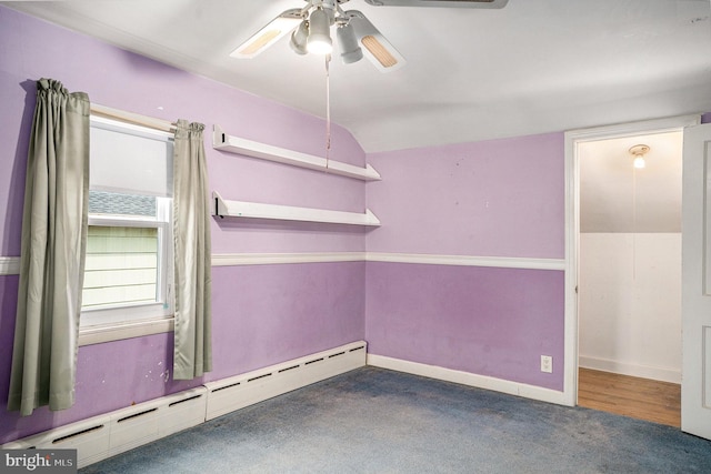 carpeted spare room with baseboards, a baseboard heating unit, and a ceiling fan