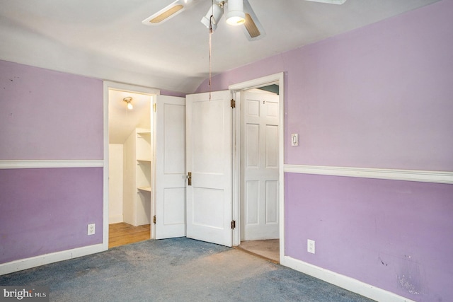 unfurnished bedroom featuring carpet flooring, a ceiling fan, and baseboards