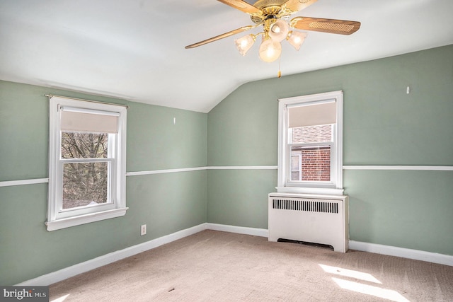 interior space featuring carpet flooring, baseboards, radiator heating unit, and a ceiling fan