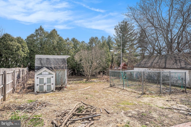 view of yard with an outbuilding, a storage shed, and fence