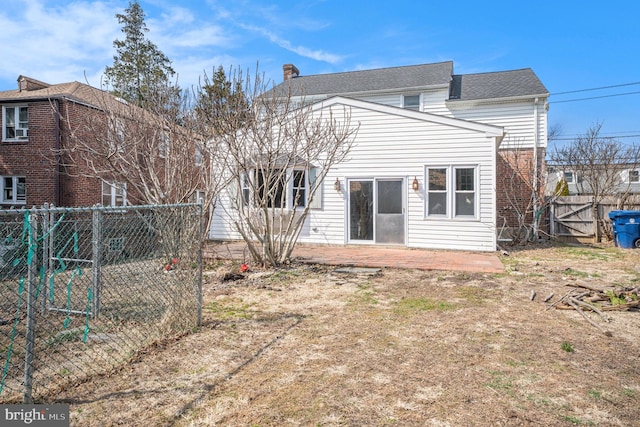 back of property with a patio, a chimney, and a fenced backyard