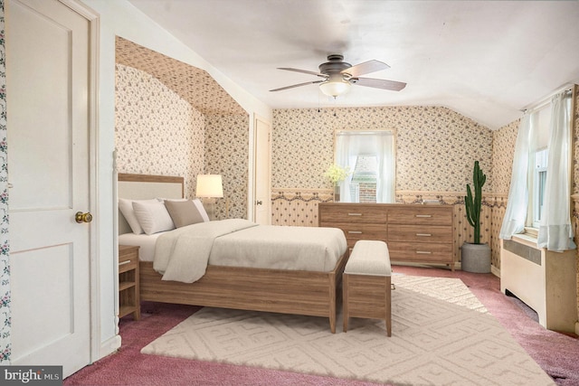 bedroom with carpet flooring, ceiling fan, wallpapered walls, and lofted ceiling