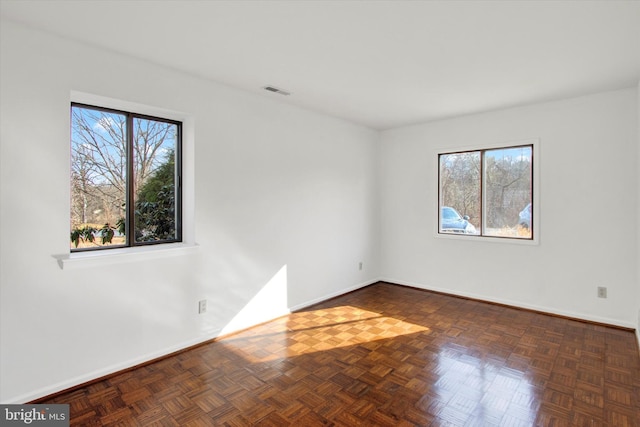 empty room featuring visible vents and baseboards