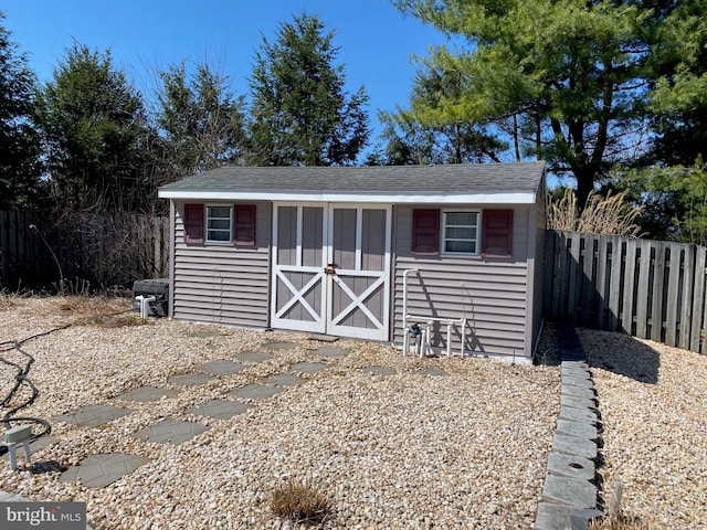 view of shed with fence