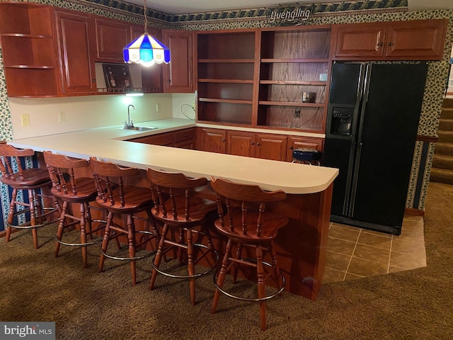 kitchen featuring a peninsula, a sink, tile patterned floors, open shelves, and black refrigerator with ice dispenser