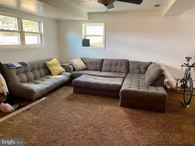 living room featuring carpet floors, visible vents, and a ceiling fan