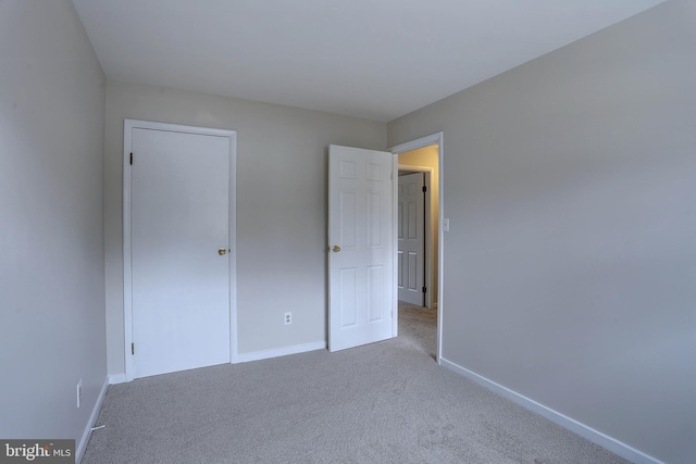 unfurnished bedroom with baseboards and carpet floors