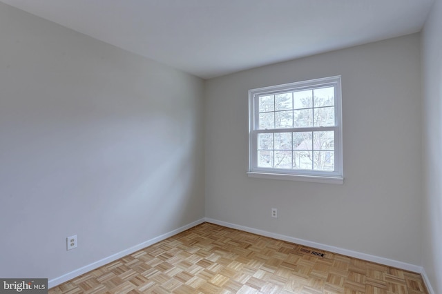 unfurnished room featuring visible vents and baseboards