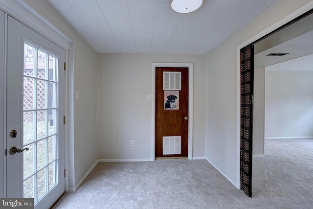 entryway with plenty of natural light, visible vents, and carpet floors