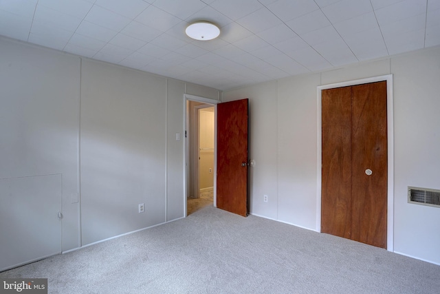 unfurnished bedroom with visible vents and carpet flooring