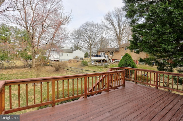 wooden deck with a lawn