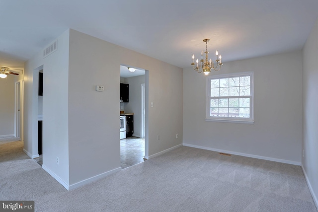 spare room with baseboards, visible vents, and light carpet