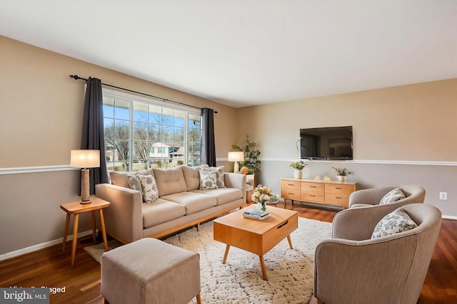 living area featuring wood finished floors and baseboards