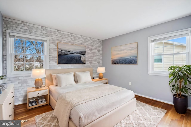 bedroom featuring baseboards and wood finished floors