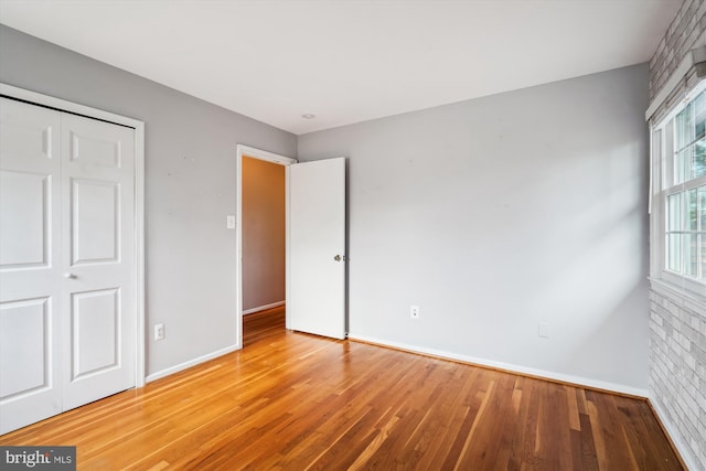 unfurnished bedroom with baseboards and light wood-style floors