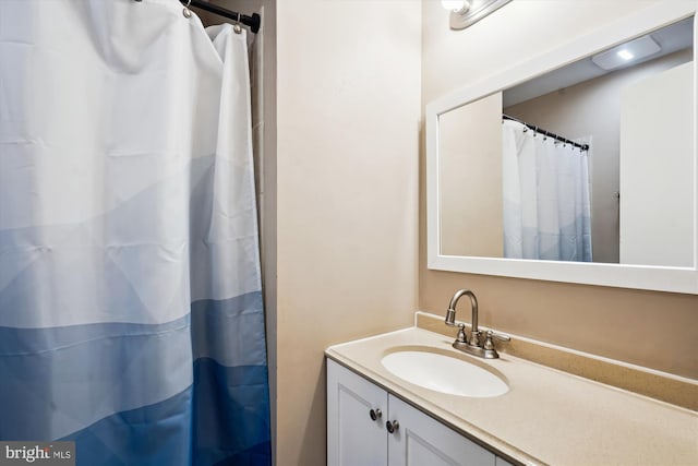 bathroom featuring curtained shower and vanity