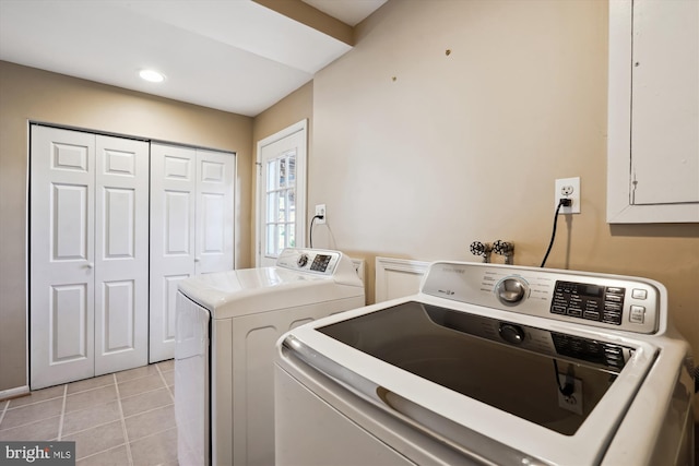 washroom featuring washer and clothes dryer, electric panel, recessed lighting, light tile patterned flooring, and cabinet space