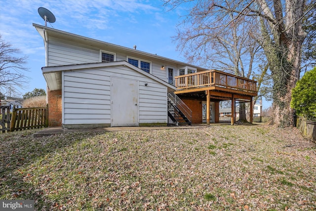 back of property featuring stairway, fence, a shed, an outdoor structure, and a deck