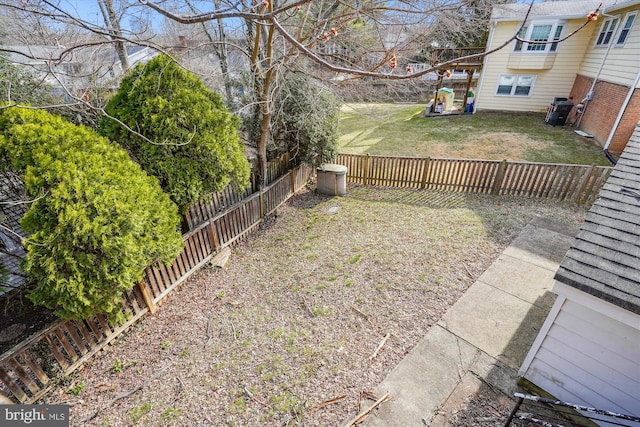 view of yard with central air condition unit and a fenced backyard